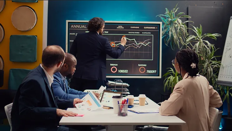 Marketing team reviewing digital campaign performance metrics