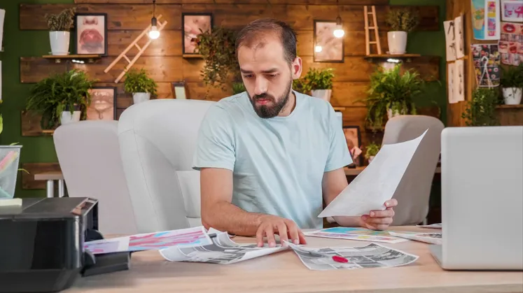 Designer reviewing creative fashion project and sketches