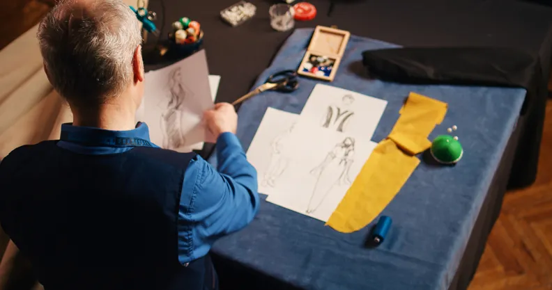 Fashion illustrator sketching original clothing design ideas